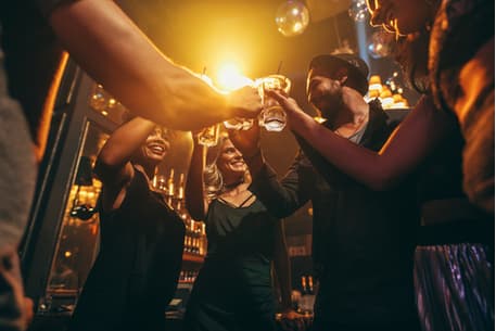 a group of friends toasting cocktails