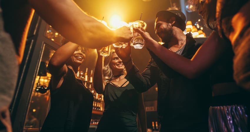 a group of friends toasting cocktails