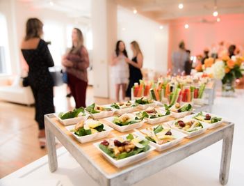 food display at a corporate gala with professionals mingling