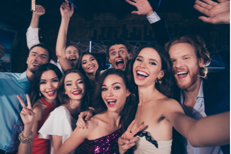 a group of friends taking a selfie before a dance