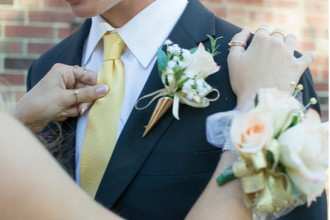teens dates wearing a corsage before prom