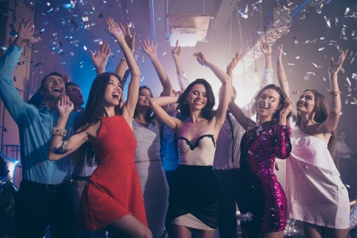 friends laugh and dance at prom dance celebration
